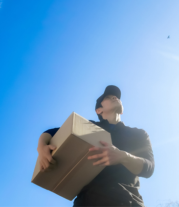 空を見て歩く宅配ドライバーの男性